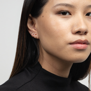 Close-up of a person wearing Stay Close Garnet Hoop with a neutral background