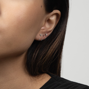 Close-up of a person wearing Stay Close Garnet Hoop with a neutral background
